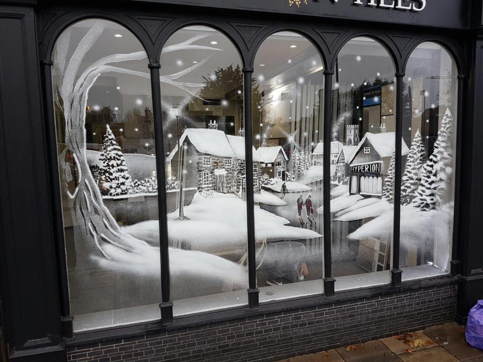 Snow window art, bespoke snow spray installations, snow spray stencils, Christmas window art, Christmas window decoration with snow spray, snow spray art number 1 snow spray artist number 1 window art easy to remove snow spray art sustainable window stencils reusable window stencils snow window