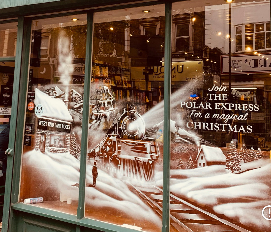 Snow window art, bespoke snow spray installations, snow spray stencils, Christmas window art, Christmas window decoration with snow spray, snow spray art number 1 snow spray artist number 1 window art easy to remove snow spray art sustainable window stencils reusable window stencils polar express train window art bookshop art