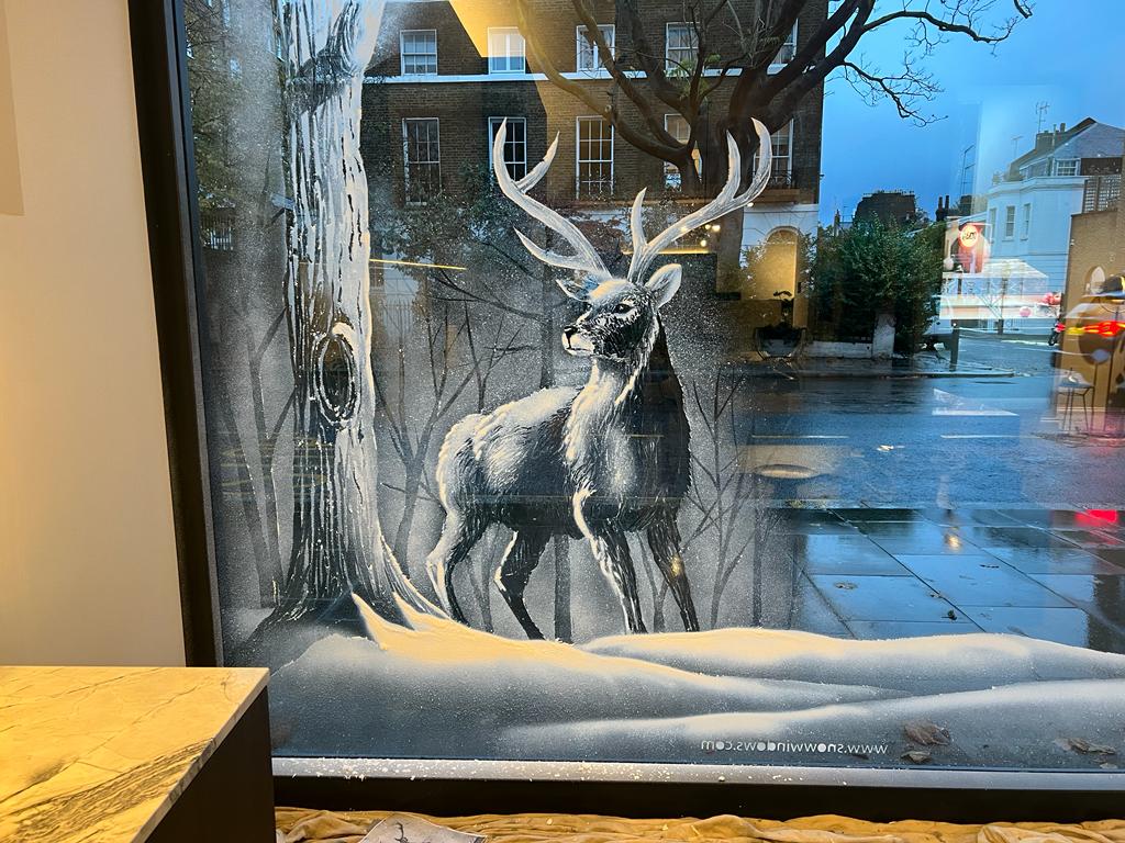 Snow window art, bespoke snow spray installations, snow spray stencils, Christmas window art, Christmas window decoration with snow spray, snow spray art number 1 snow spray artist number 1 window art easy to remove snow spray art sustainable window stencils reusable window stencils