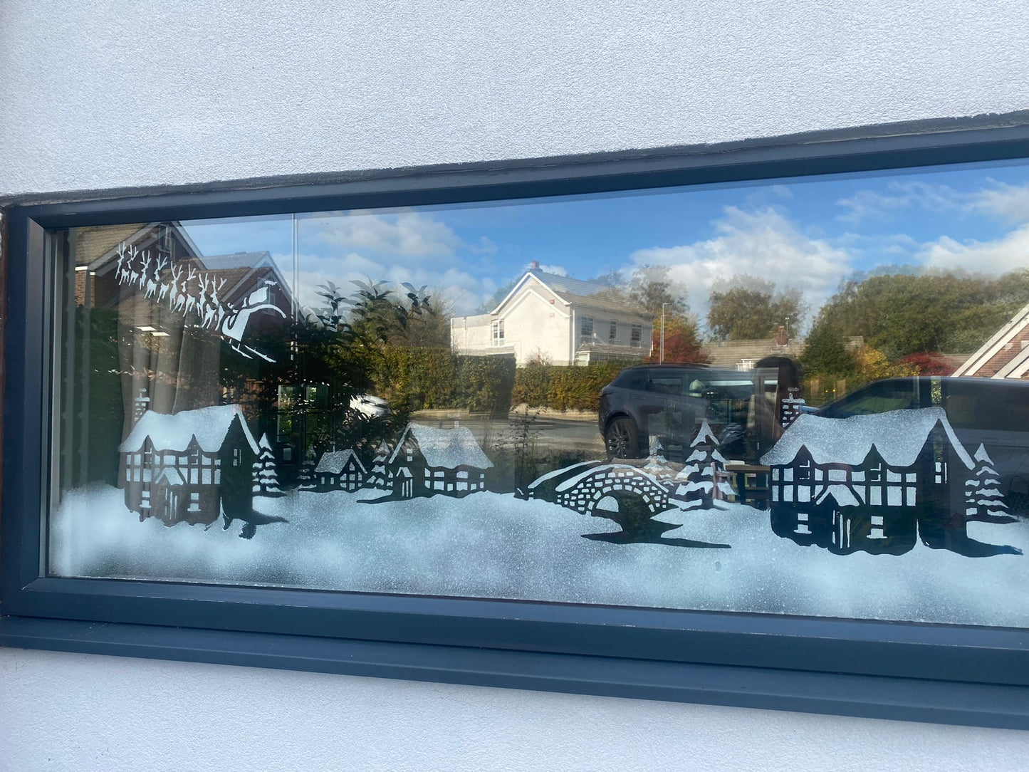 Snow window art, bespoke snow spray installations, snow spray stencils, Christmas window art, Christmas window decoration with snow spray, snow spray art number 1 snow spray artist number 1 window art easy to remove snow spray art sustainable window stencils reusable window stencils